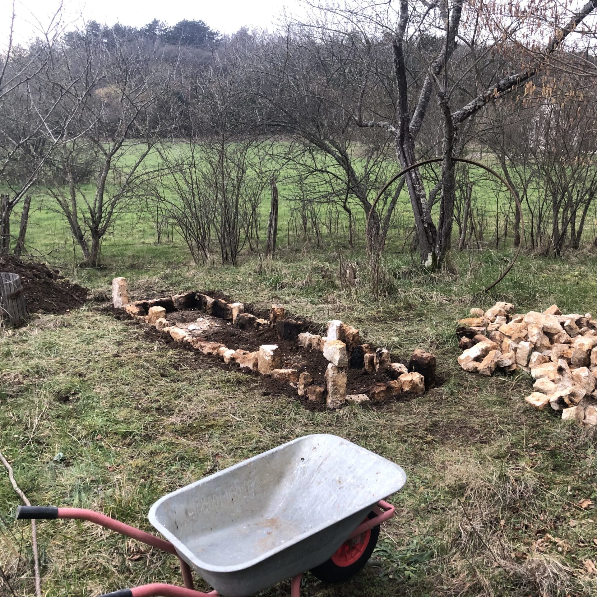Converting chimney stones into a raised garden bed